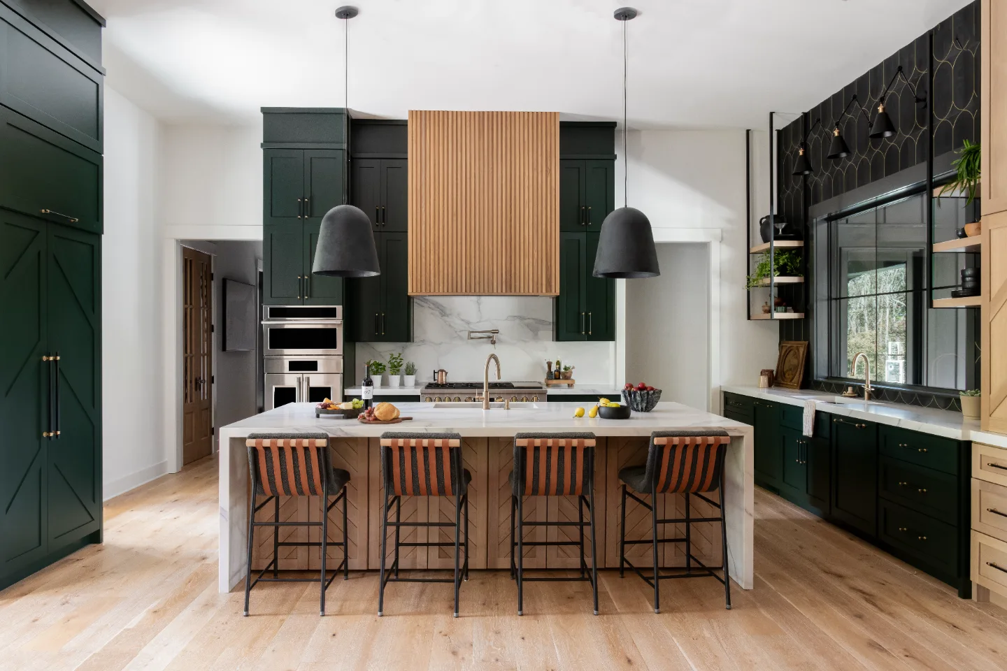 A unique-luxurious whole-home remodel in Columbia, TN with a deep green Jasper kitchen, Calacatta Troy quartzite waterfall island, and 3D carved black brass tile backsplash by Sebring Design Build.