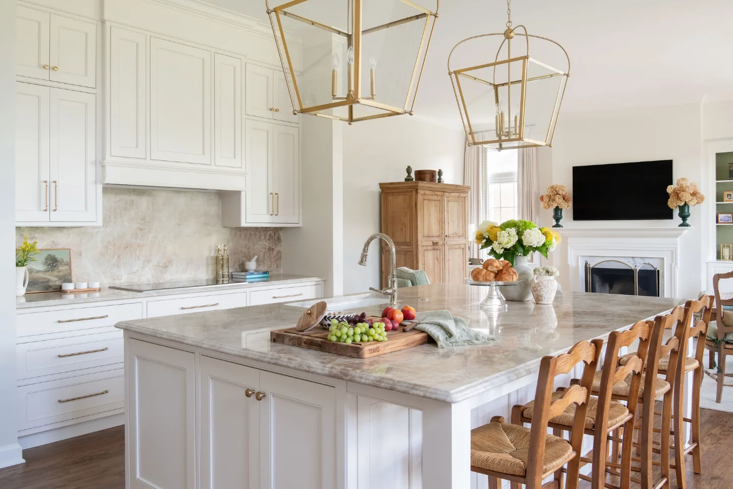 A refined Provencal kitchen in Horseshoe Bend featuring Ivory Lace recessed-panel cabinetry, natural stone countertops, Honey Bronze hardware, and polished nickel fixtures.