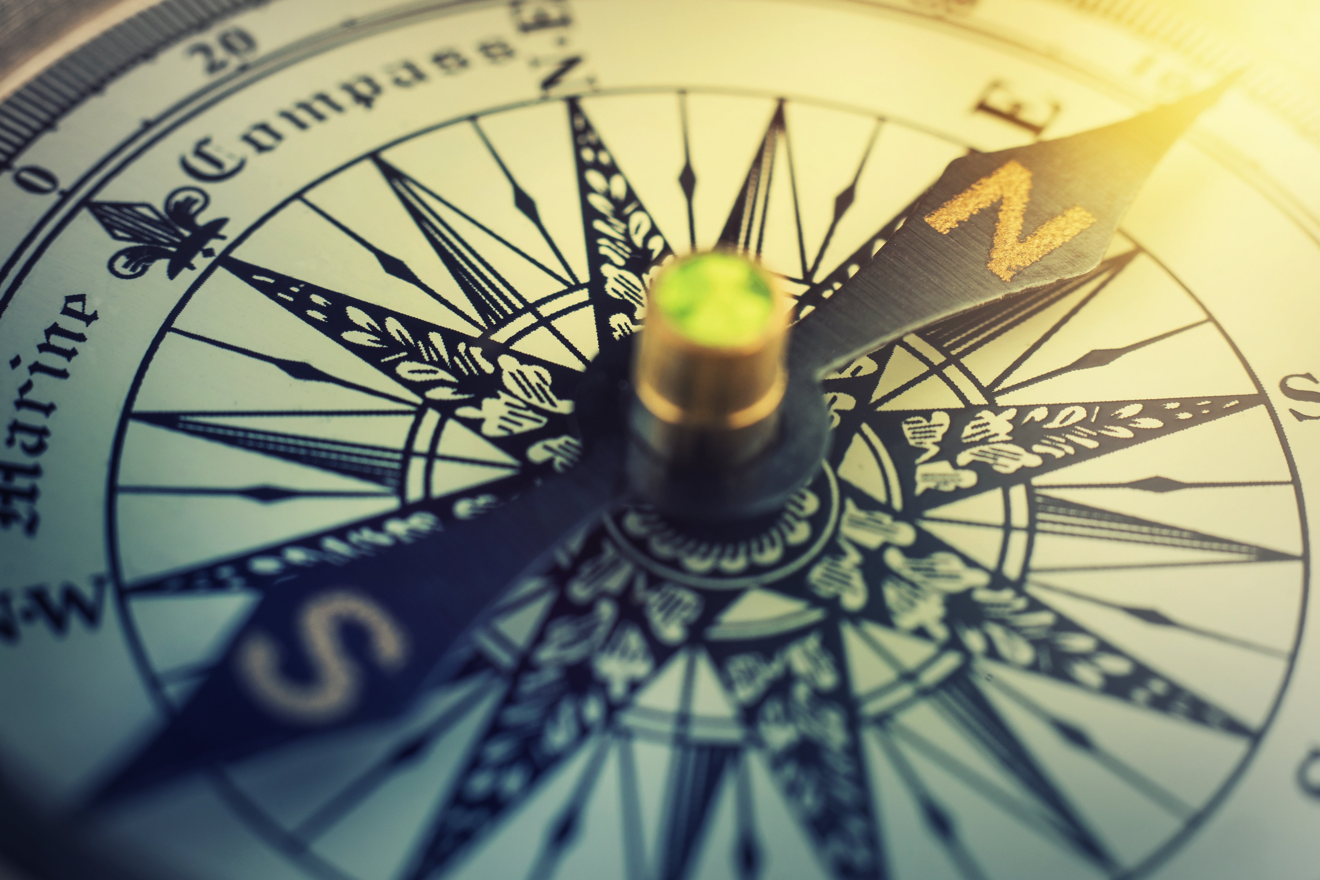 Antique compass on a nautical chart