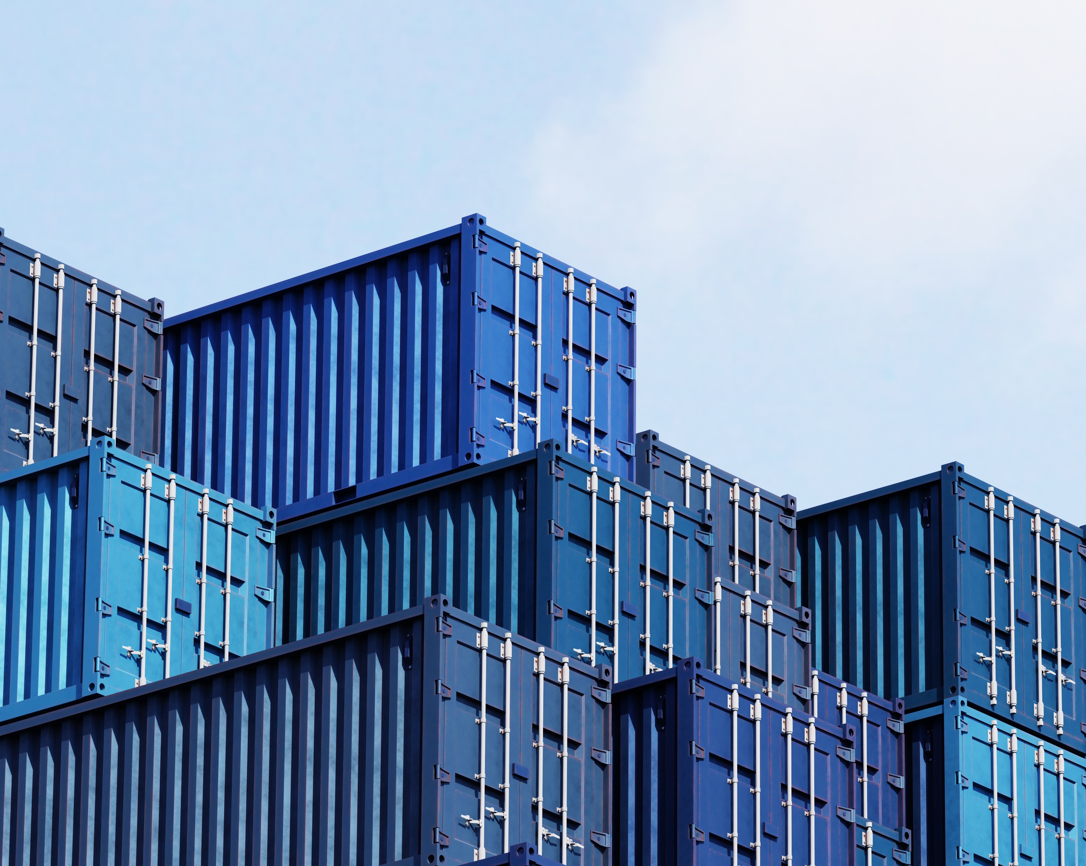 Stacked blue shipping containers against the sky