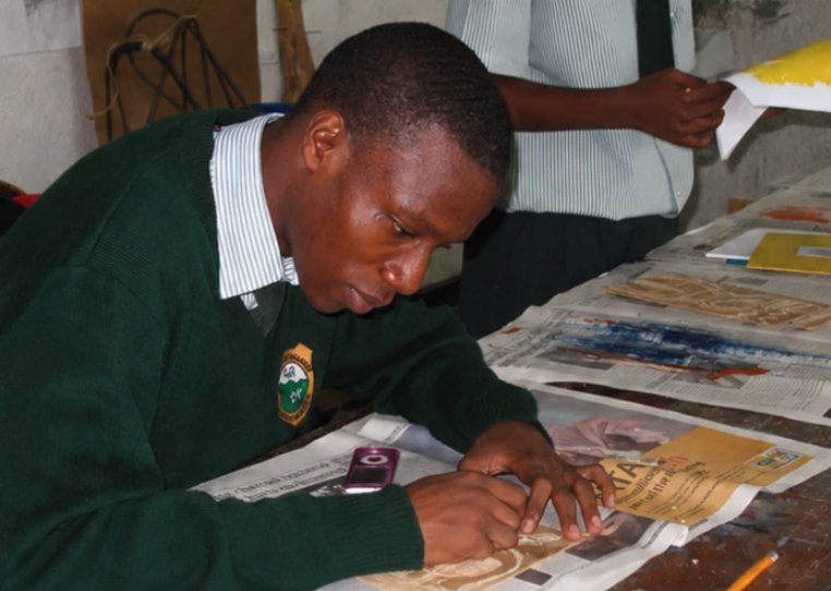 A student developing their art portfolio during a school workshop