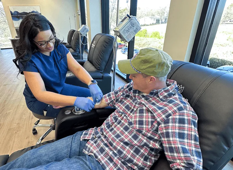 Nurse infusing patient at BluHaven Health