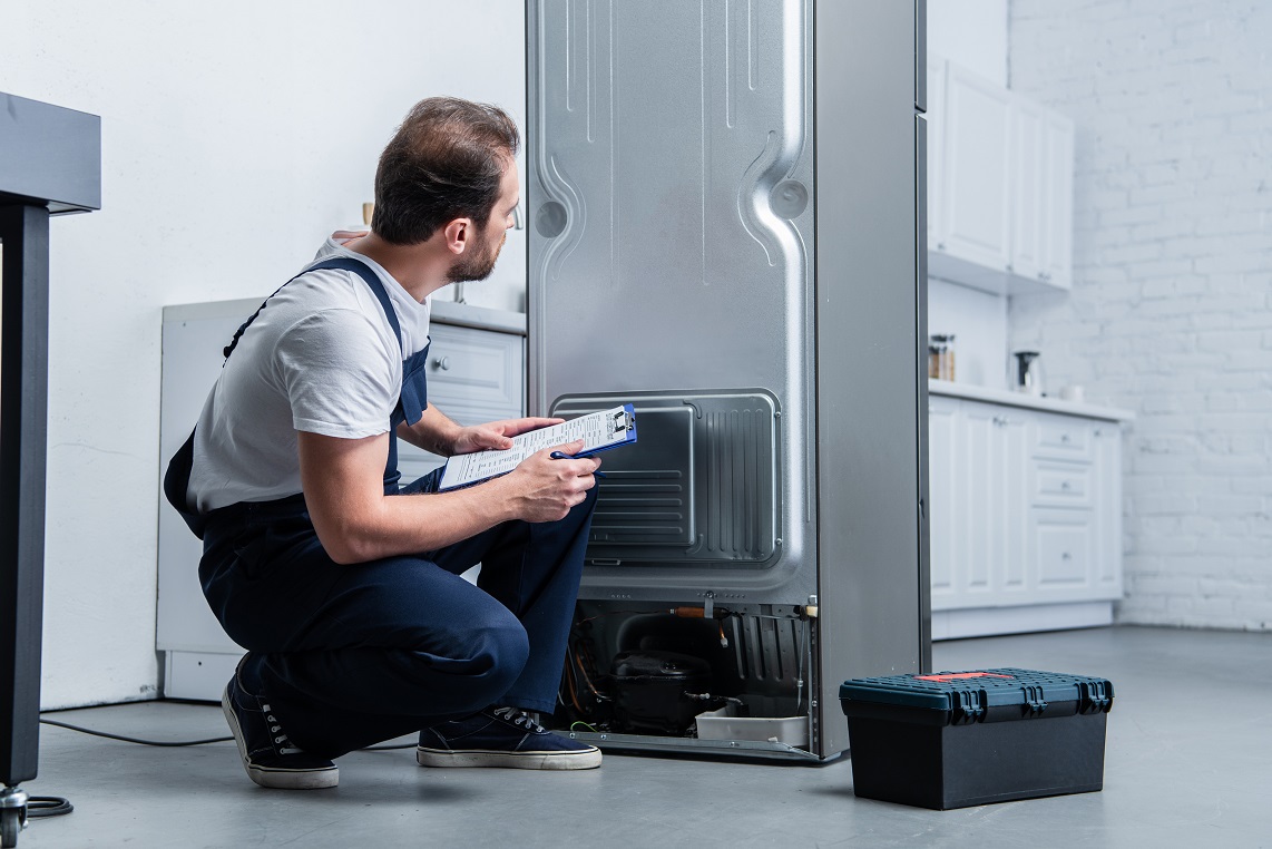 young man checking the refrigerator