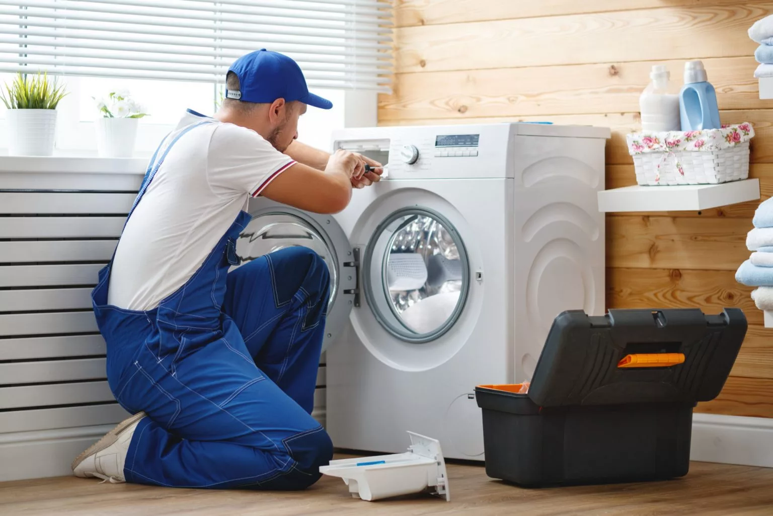man repairing laundry dryer