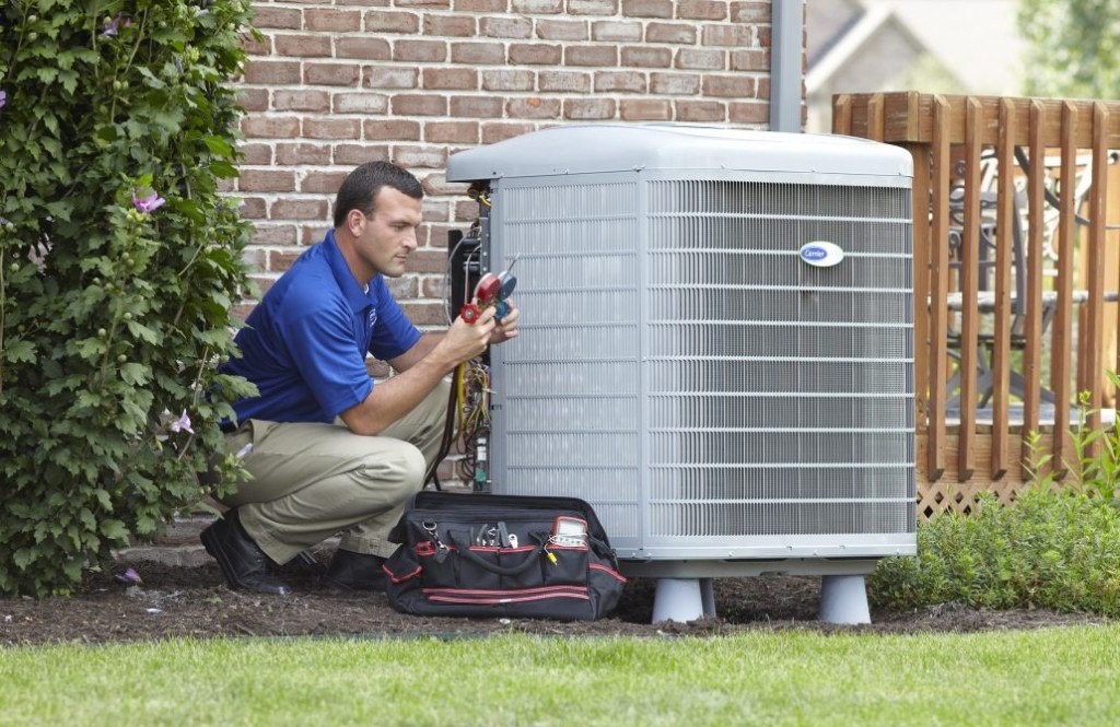 man checking the heat pump 