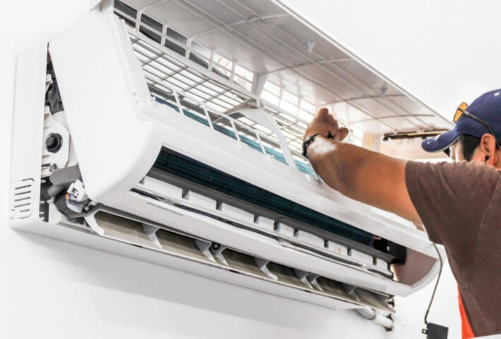 man fixing aircon filter