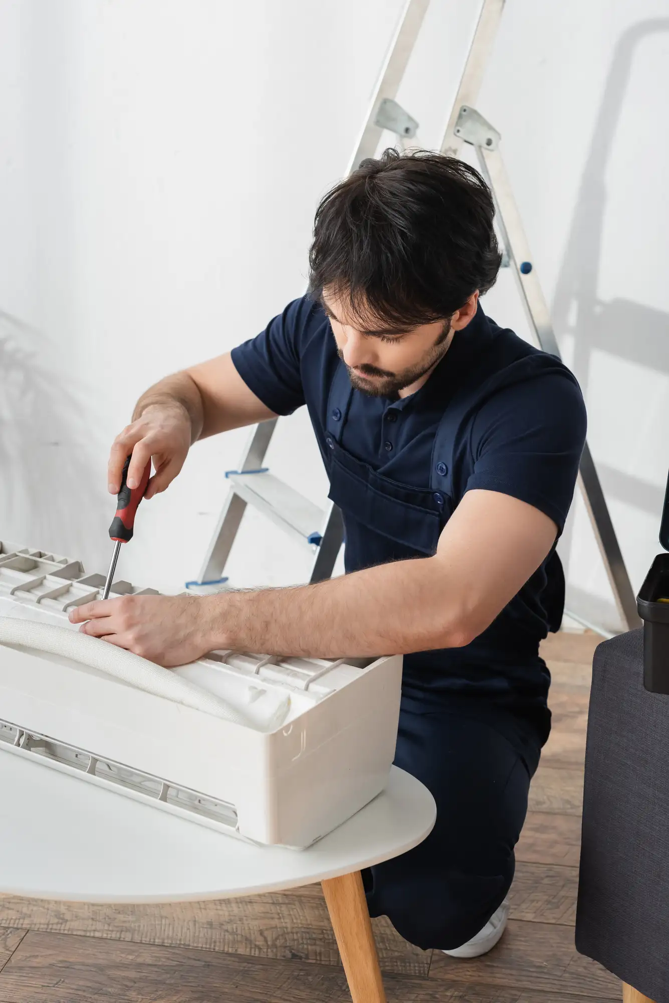 Man fixing an air condioner