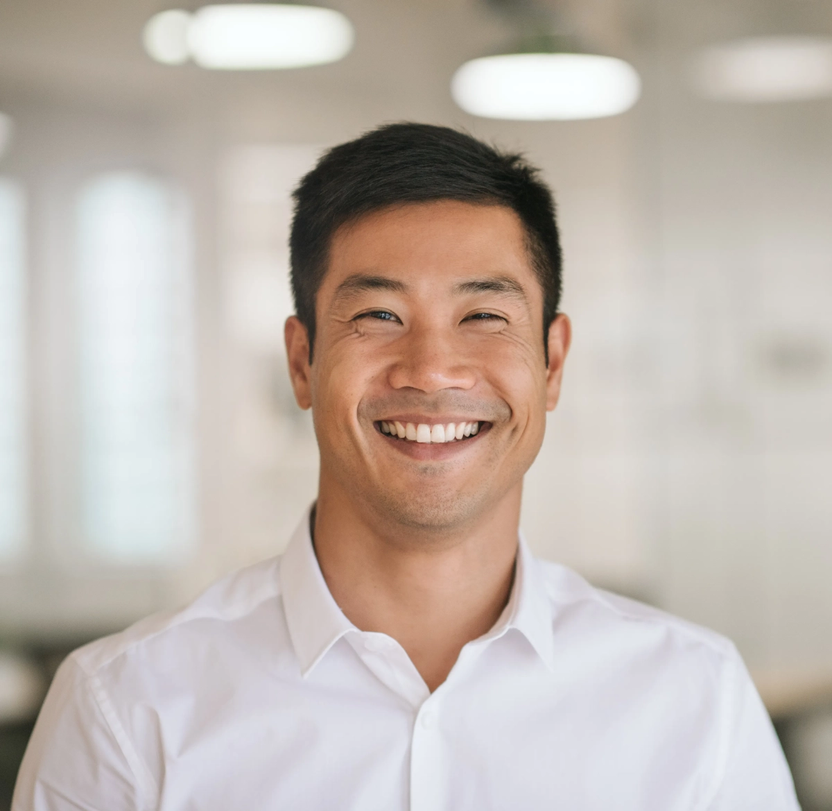 Man in a white shirt smiling