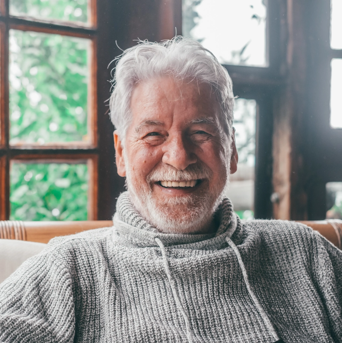 Smiling senior man in a grey sweater