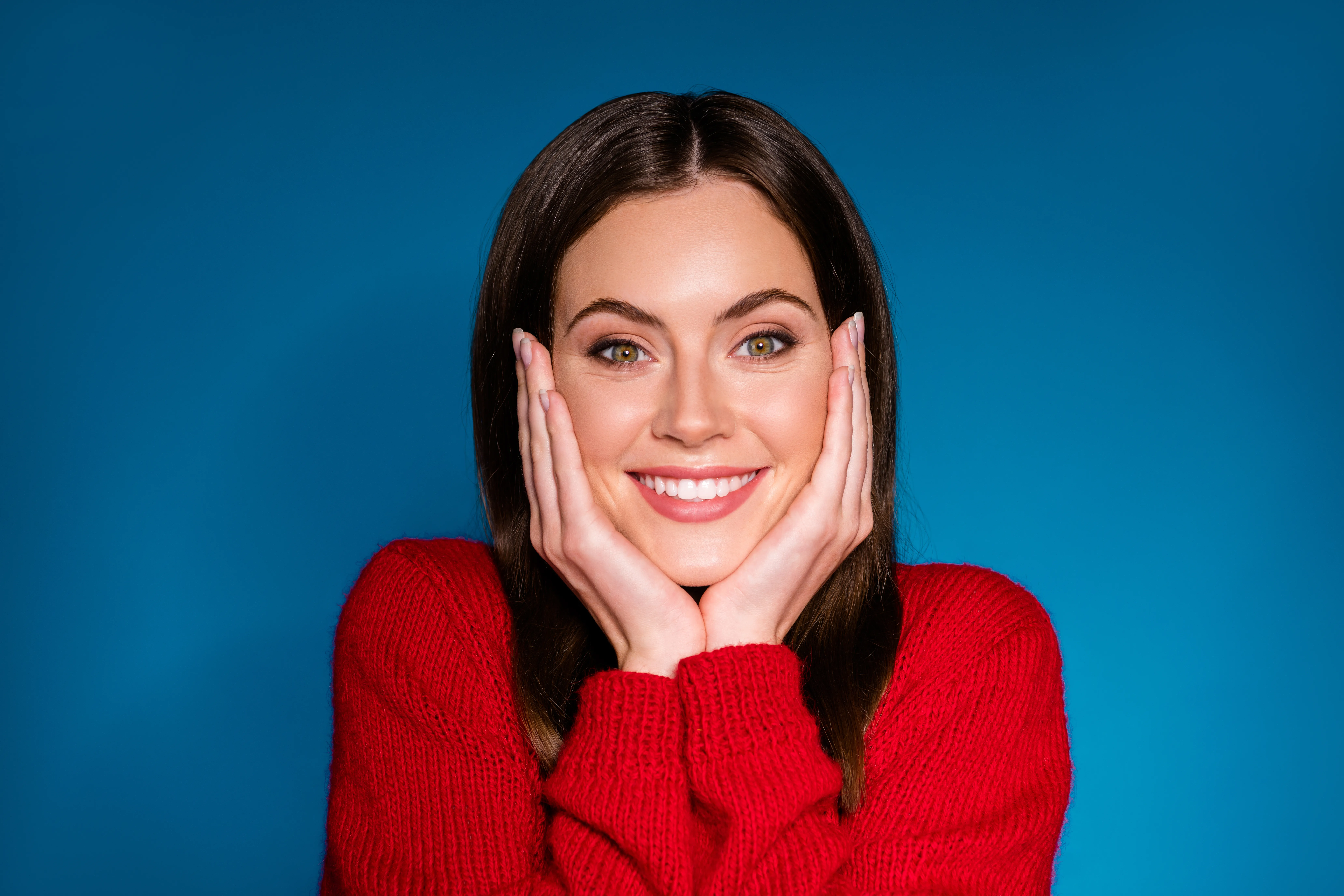 Patient displaying confident, radiant smile after comprehensive smile makeover treatment