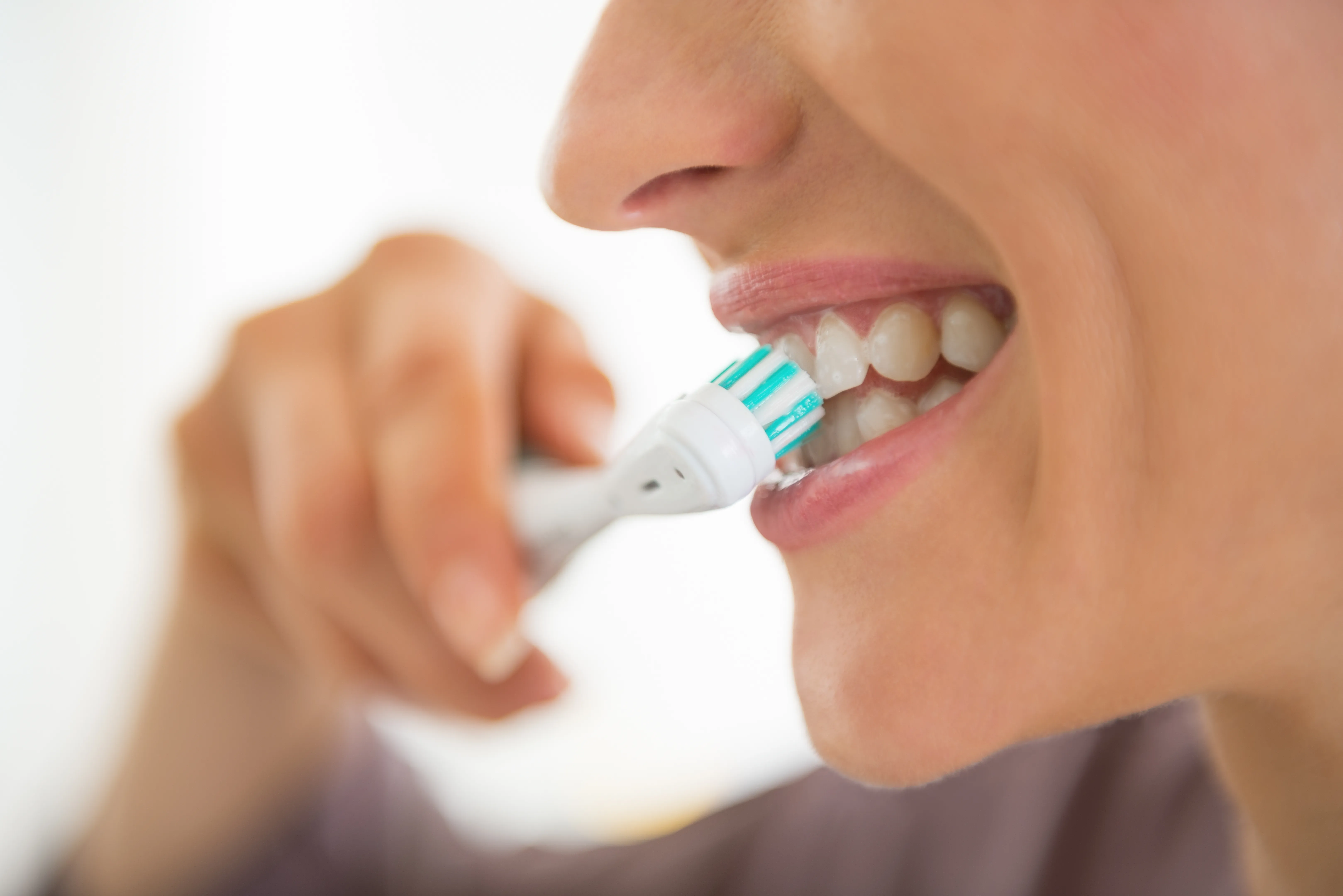 Close-up of hands and mouth area showing first aid or tooth handling