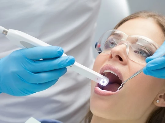 Intraoral camera being used inside a patient's mouth during examination or documentation