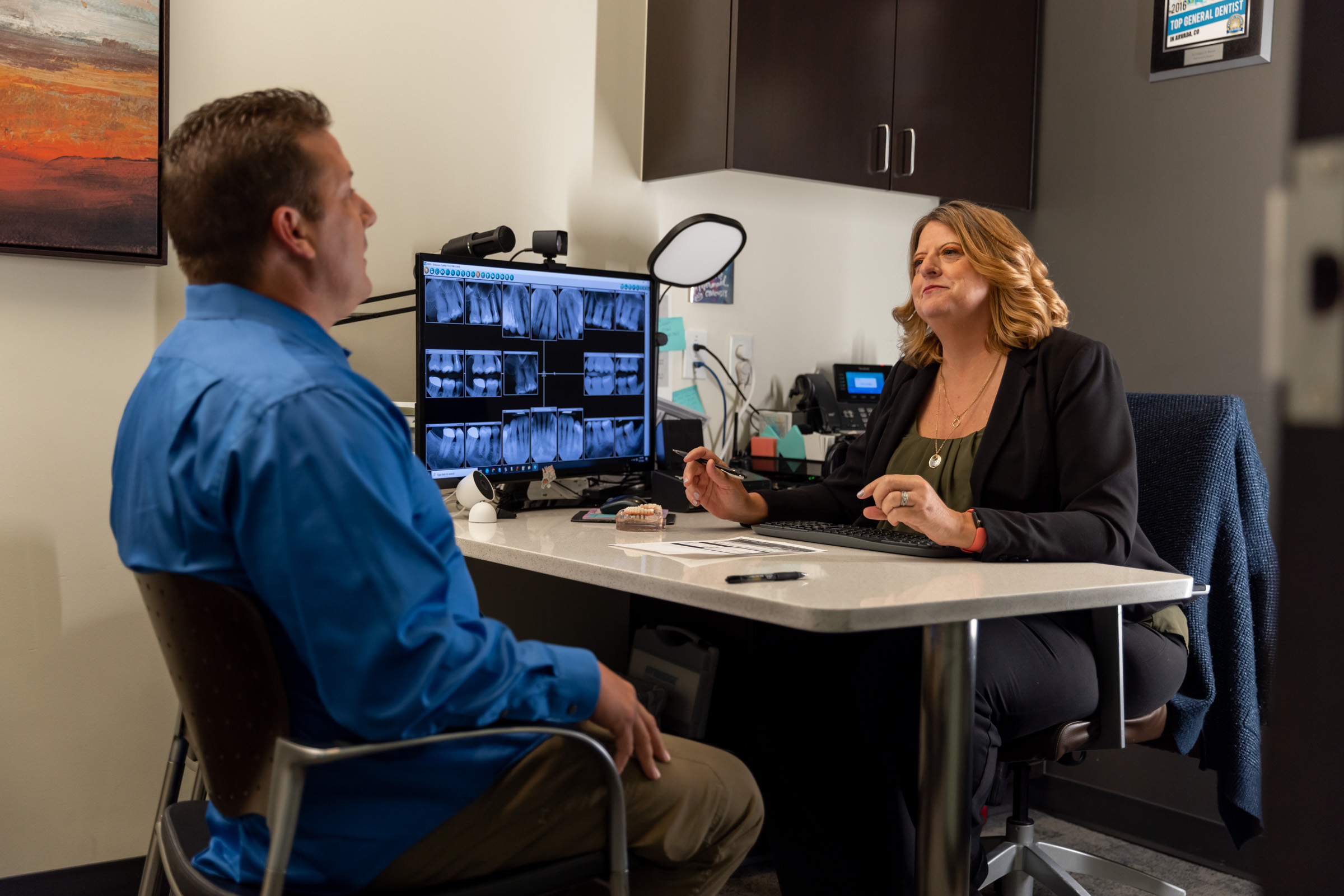 Financial coordinator explaining dental implant costs and financing options to a patient at Hackensack Center for Dental Implants