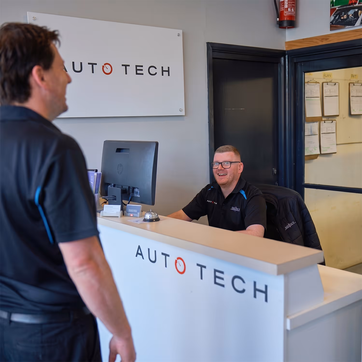 Auto Tech Group staff members assisting a customer.