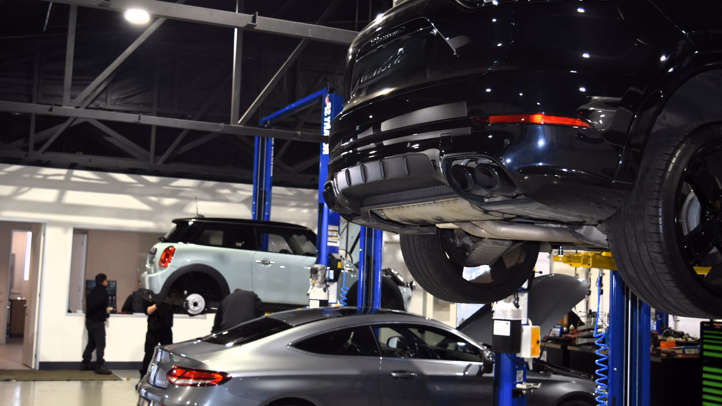Technician explaining brake condition to customer during vehicle inspection.
