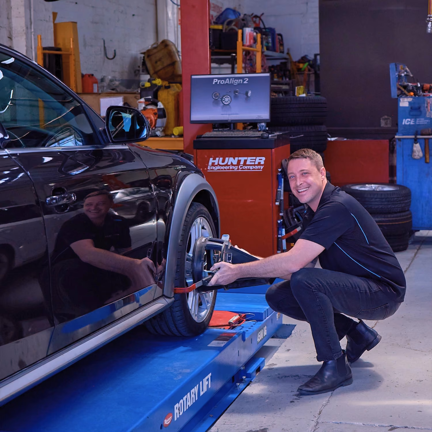 Auto Tech Group technician fixing a vehicle’s wheel.