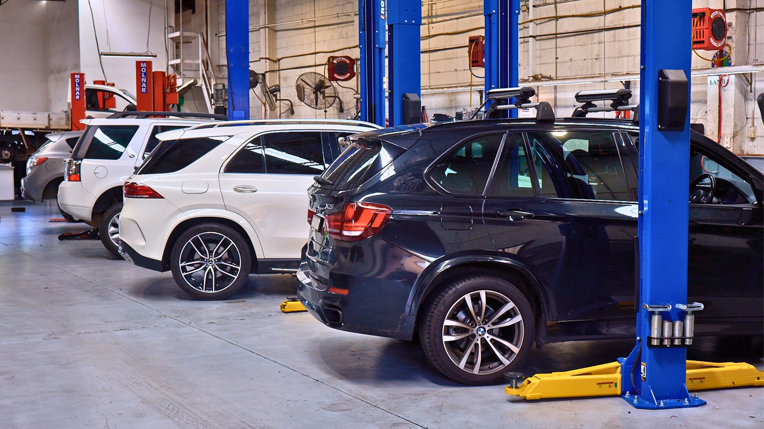 Cars lined up in an Auto Tech Group workshop for tyre service and maintenance in Melbourne.