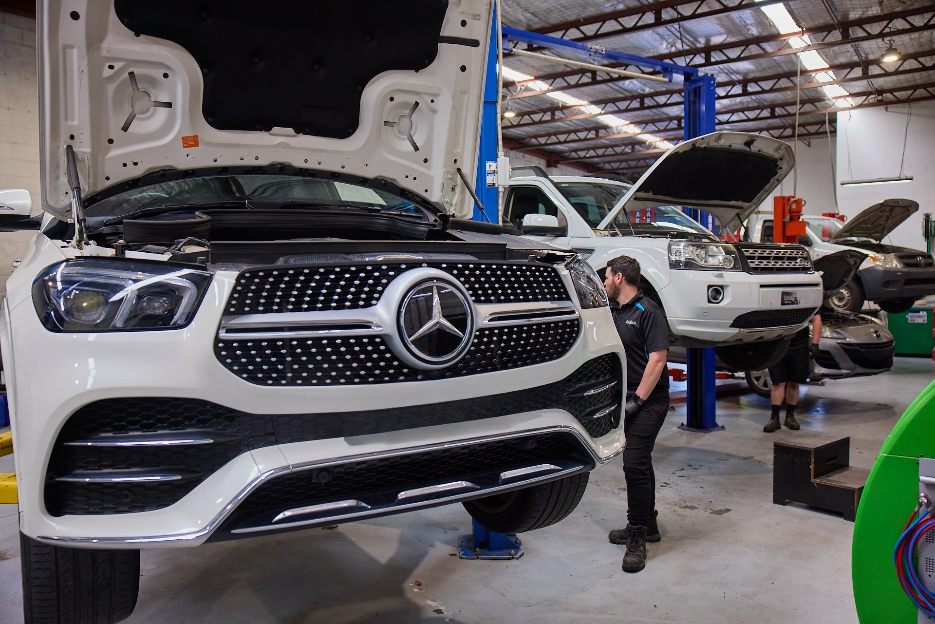 Mercedes-Benz SUV undergoing inspection and maintenance at an independent European workshop.