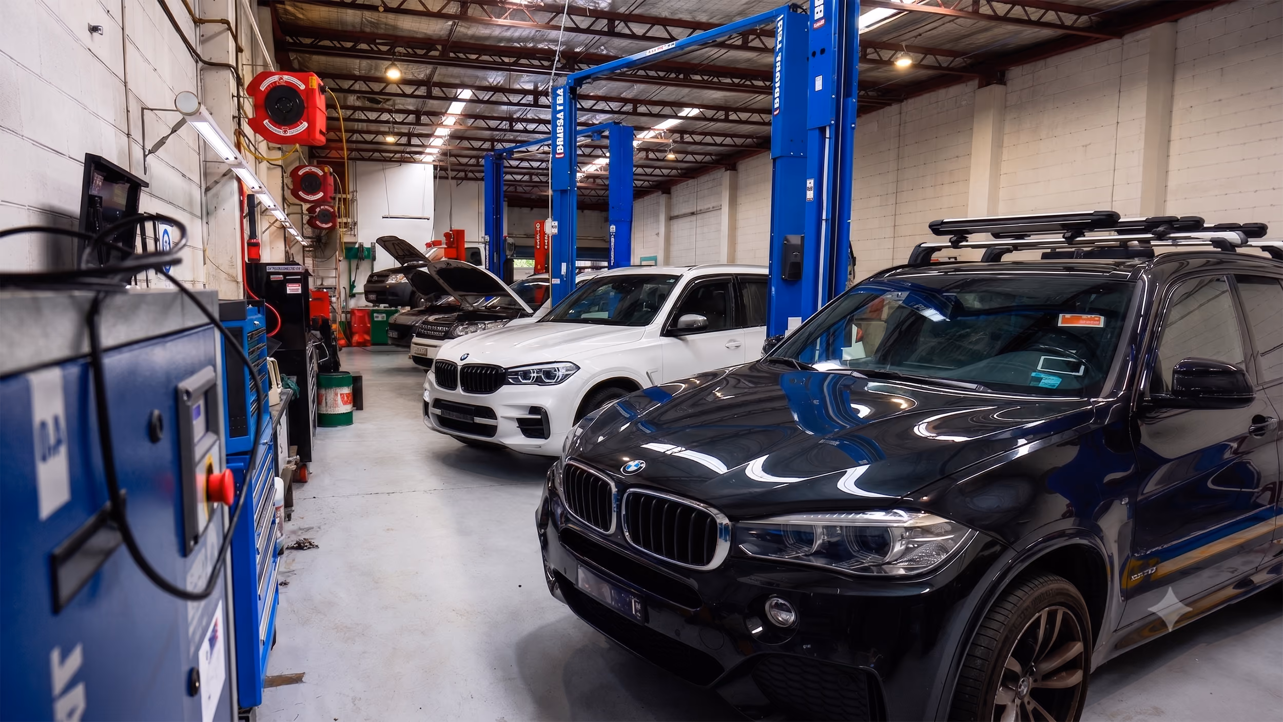 BMW brake disc replacement by technician in Auto Tech workshop.