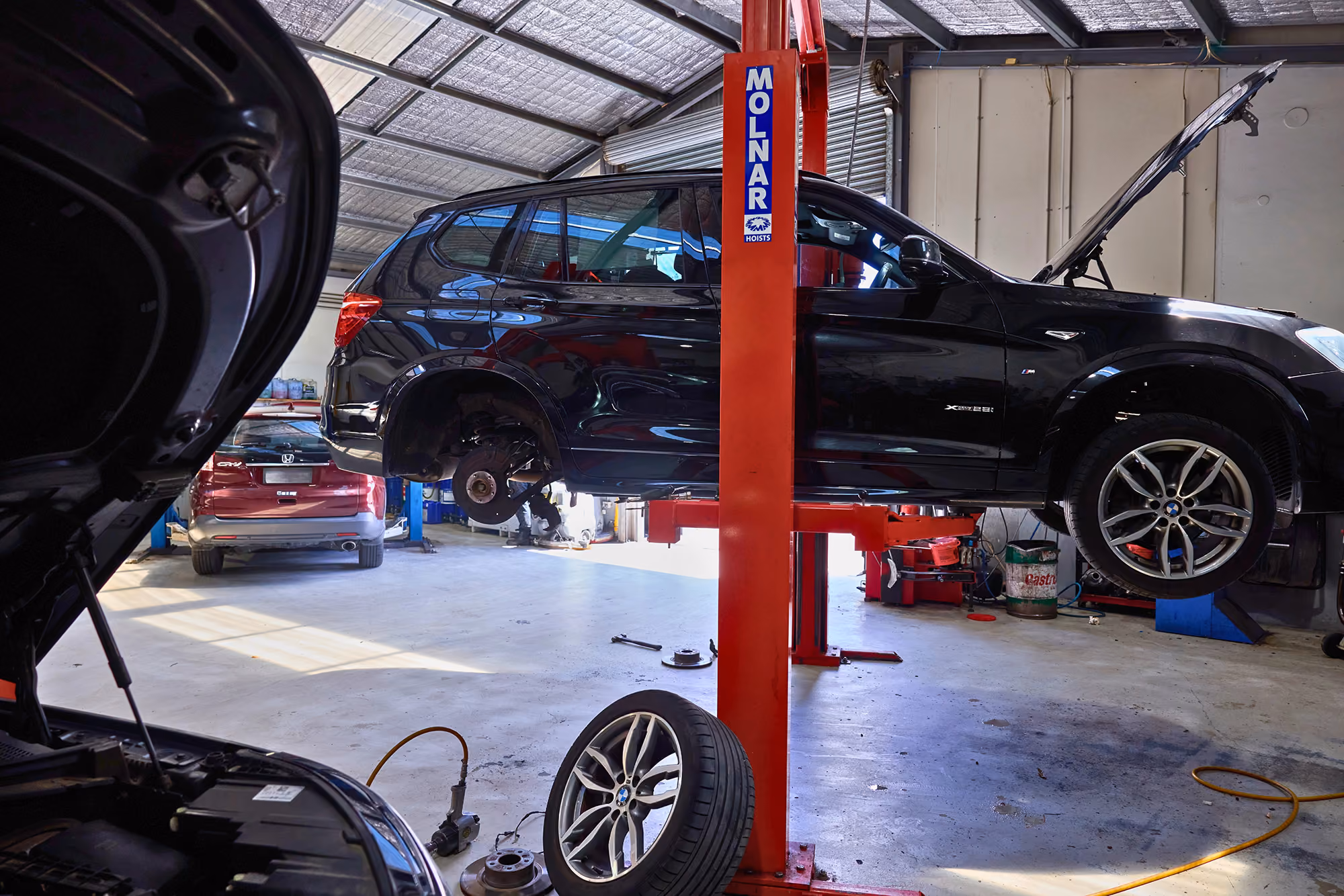 BMW SUV undergoing maintenance and repair in a specialist European workshop.