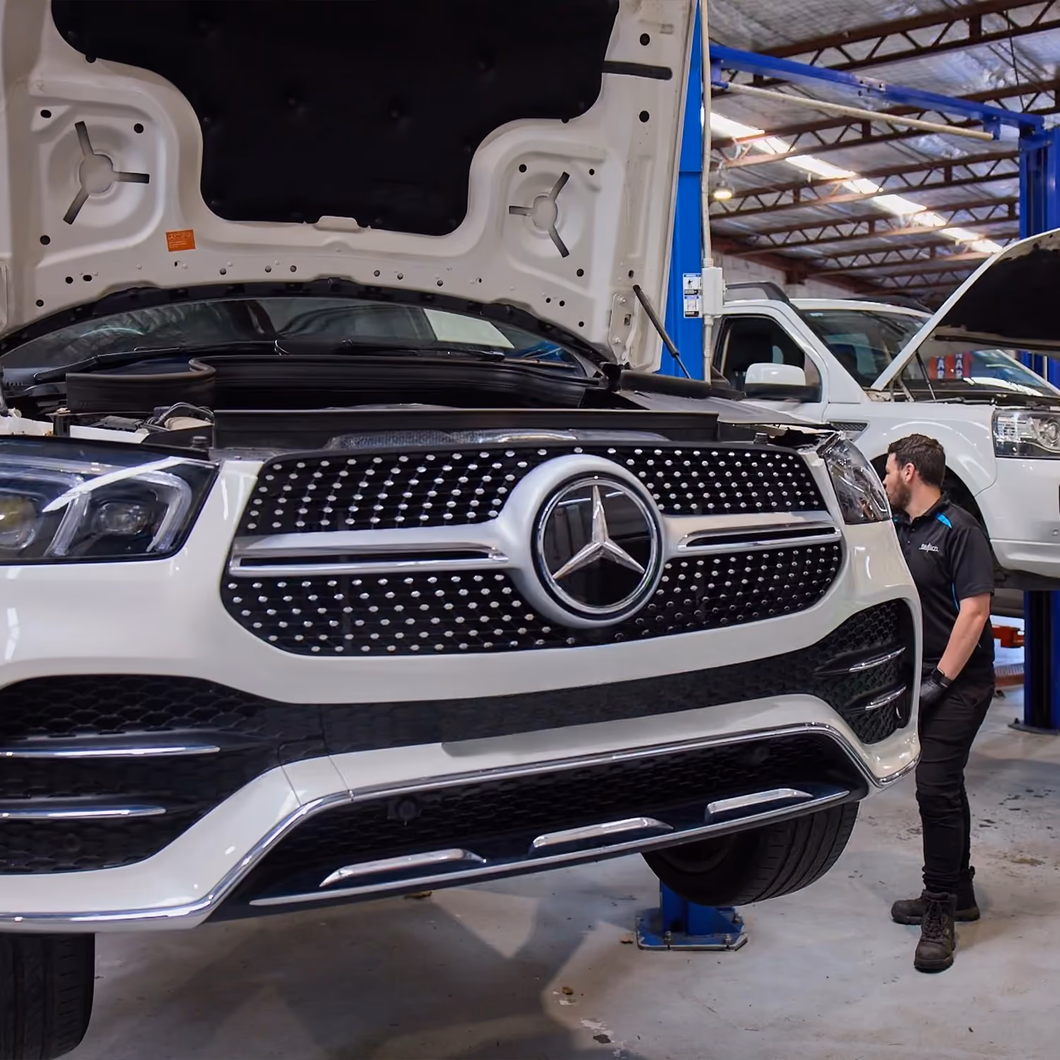 Vehicles on hoists inside Melbourne workshop during car servicing and repairs.