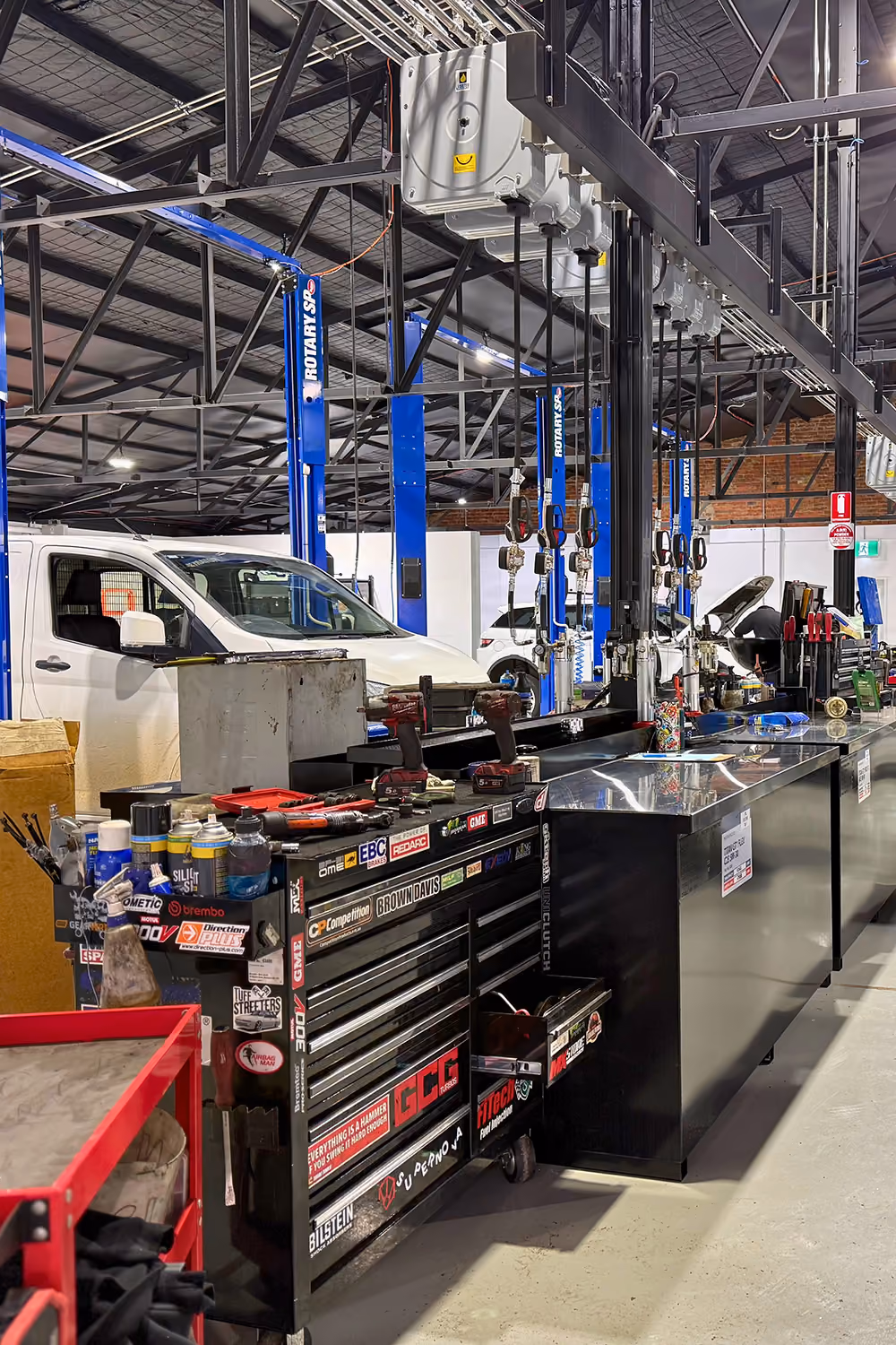 Interior of the Weir Street workshop with vehicles in multiple service bays.