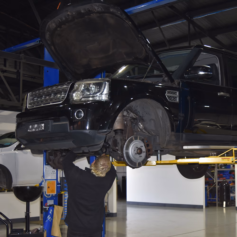 Range Rover on a workshop hoist during preventative maintenance work.