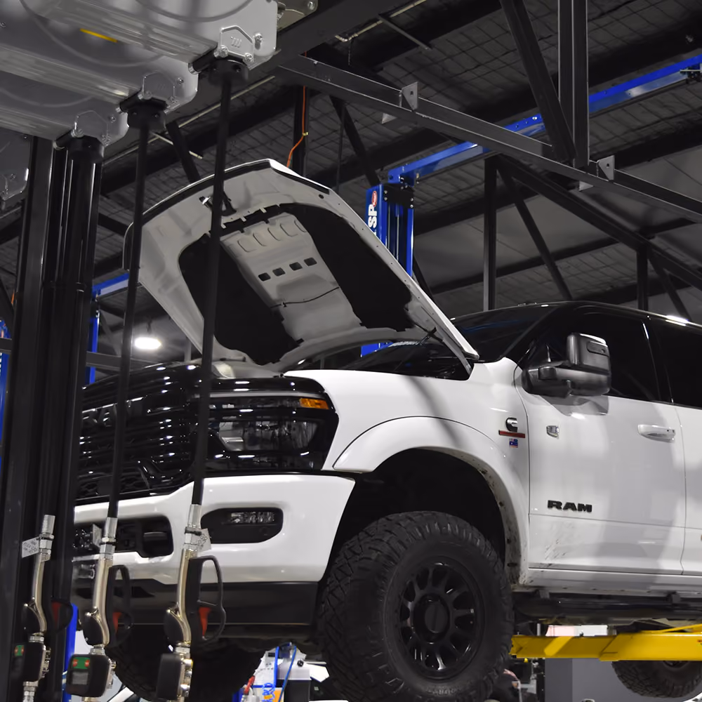 RAM vehicle raised on a workshop hoist during a log book service.