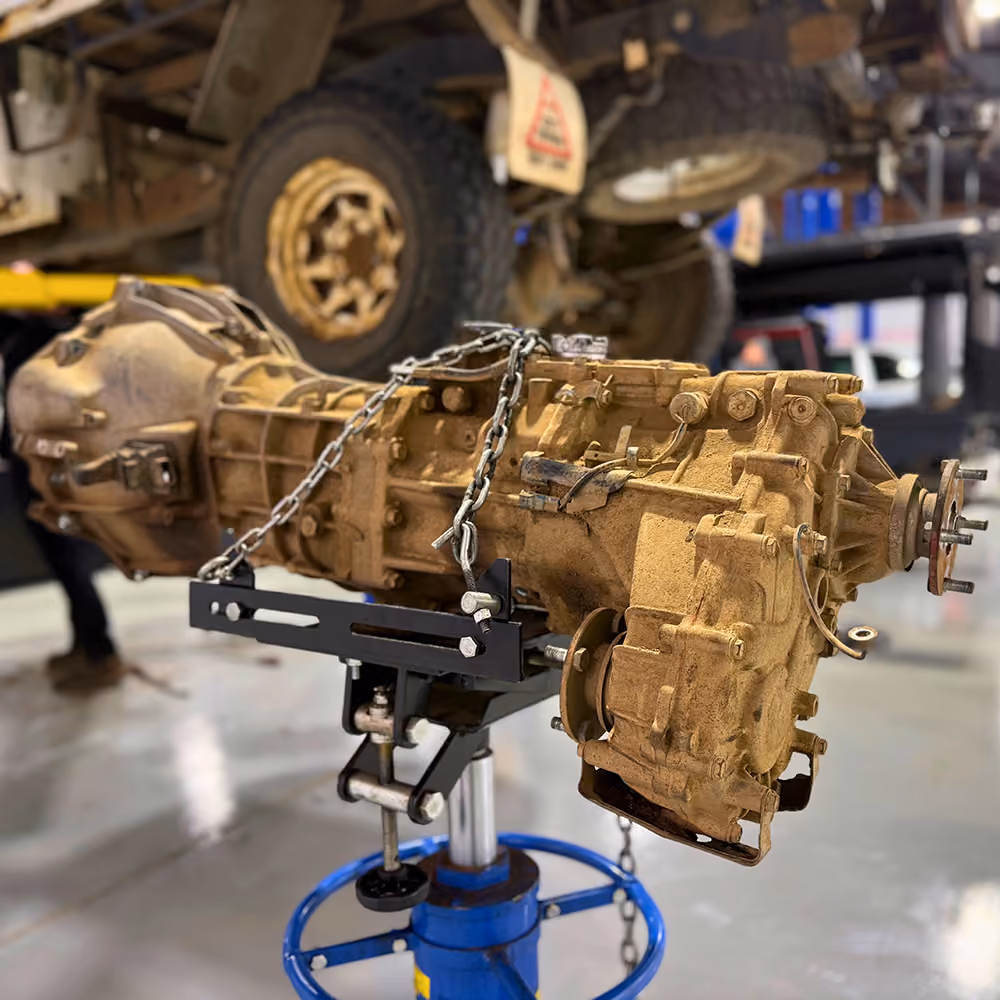Technician working on gearbox components during a transmission service.