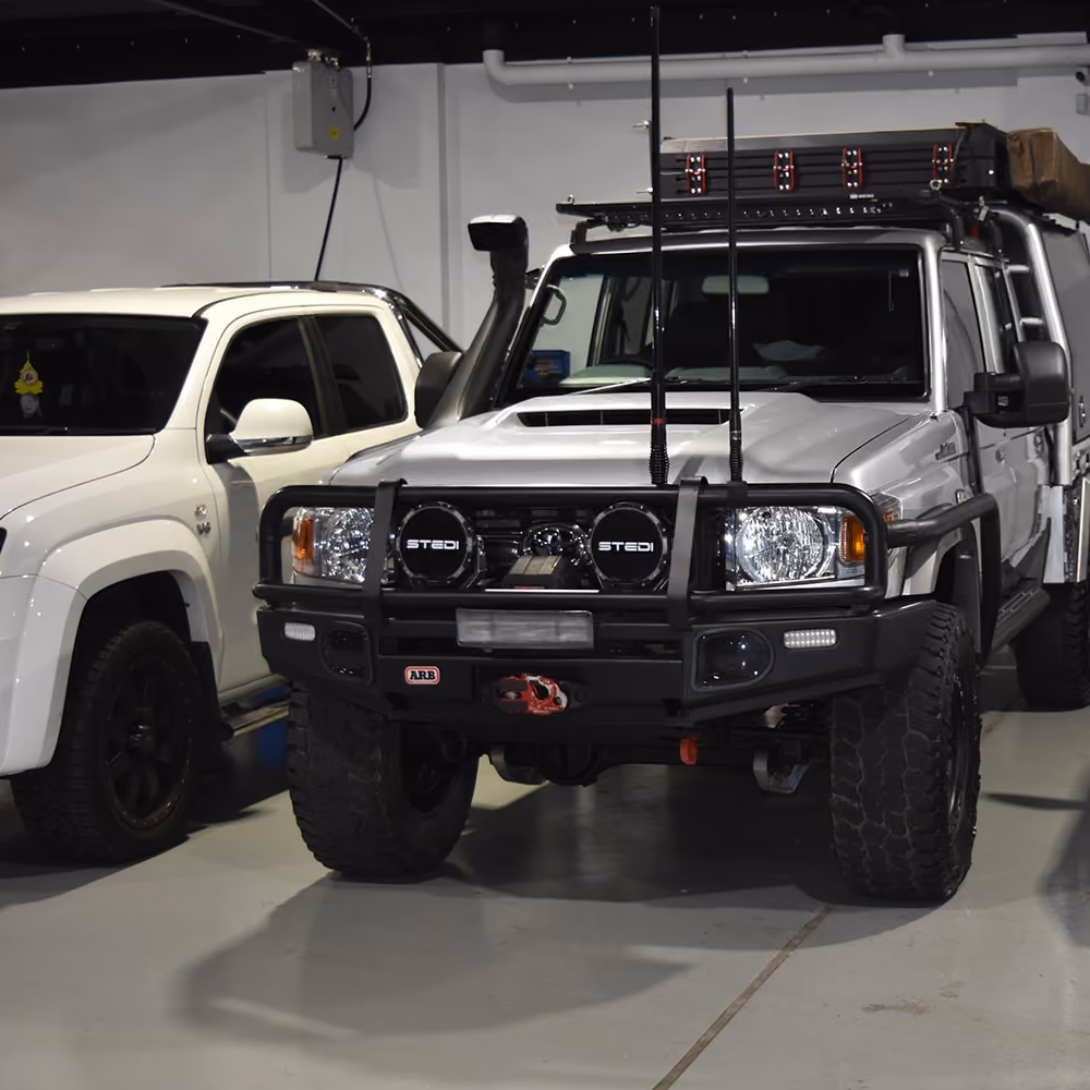 Toyota and Mazda vehicles parked together inside the workshop.