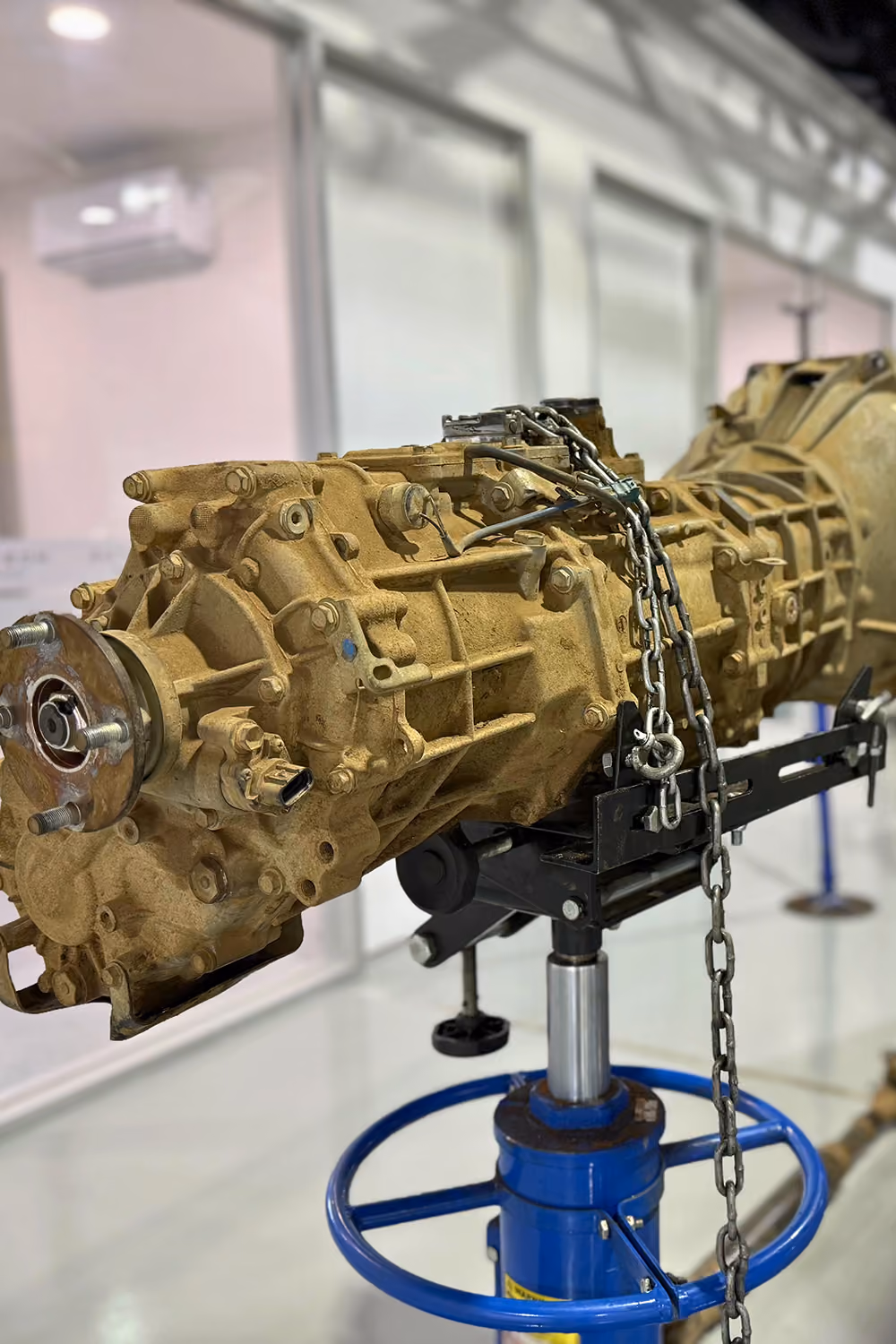 Vehicle transmission mounted on a workshop stand ready for inspection or repair.