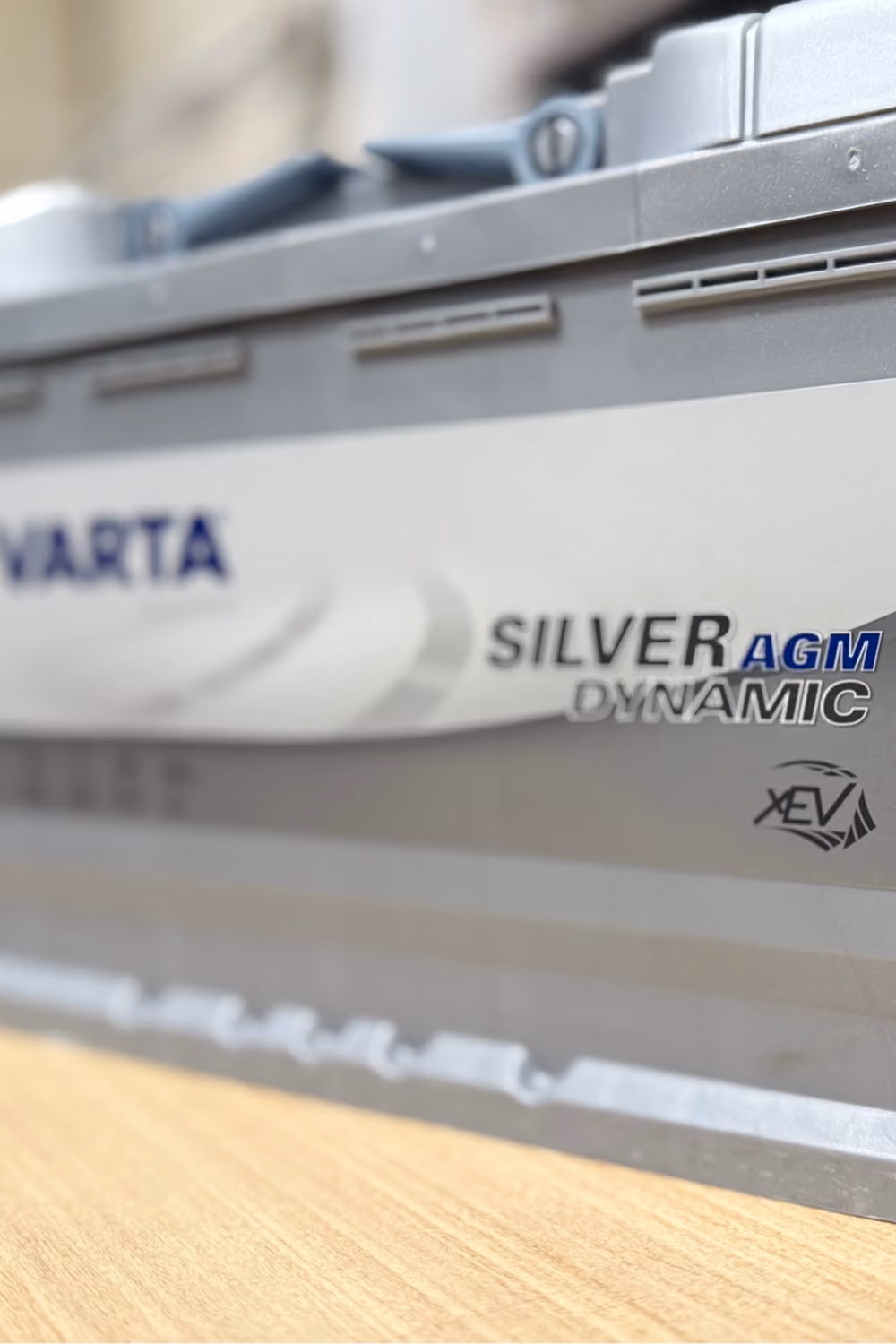 Close-up of a VARTA Silver AGM automotive battery for vehicle battery replacement and maintenance.