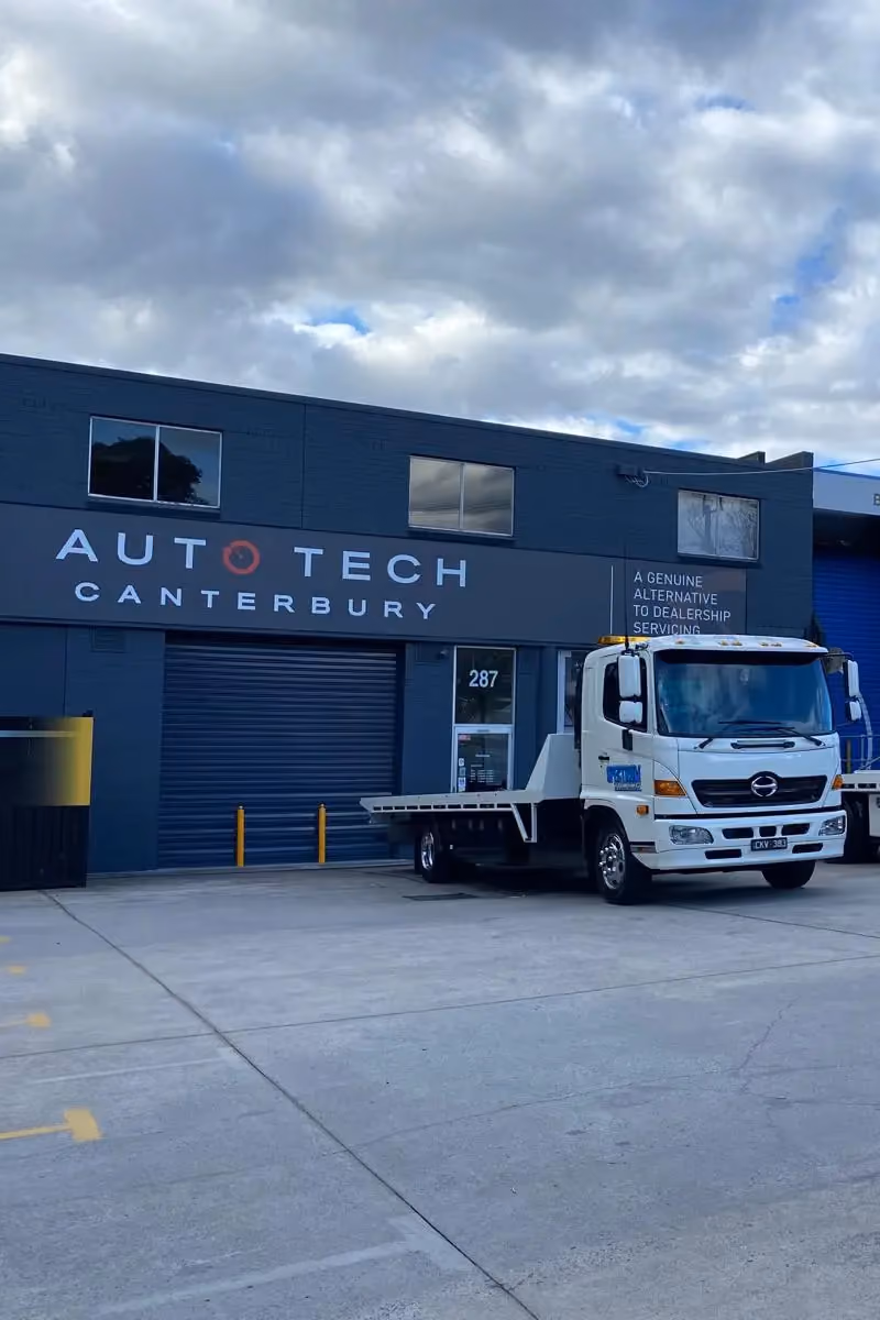 Tow truck parked outside AutoTech Canterbury workshop for vehicle towing and recovery services.