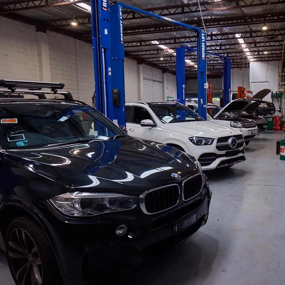 Prestige vehicles in the Auto Tech Group workshop await pre-purchase inspections and servicing.
