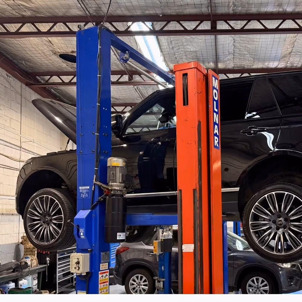 Range Rover undergoing specialist servicing on a vehicle hoist at an Auto Tech Group workshop.