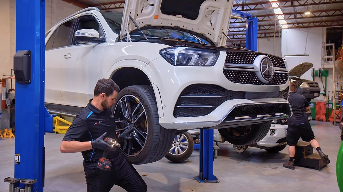 Auto Tech Group technician servicing a Mercedes-Benz SUV in a Melbourne workshop.
