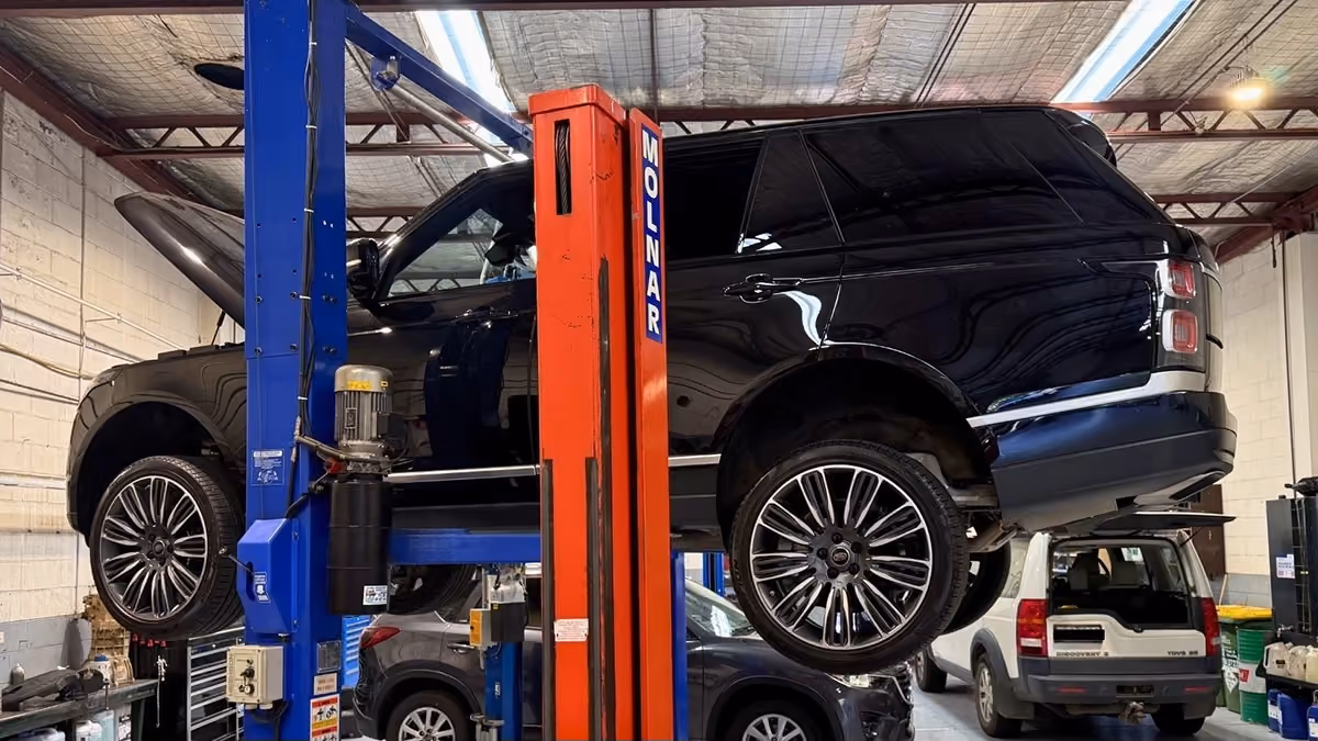 Range Rover on a vehicle hoist during specialist servicing at Auto Tech Group's Melbourne workshop.
