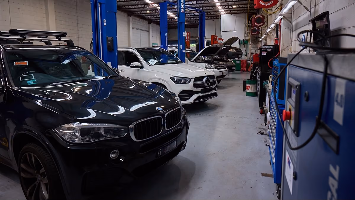 BMW and Mercedes-Benz fleet vehicles being serviced in Auto Tech Group's workshop.