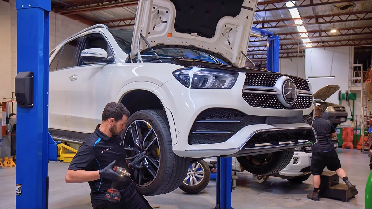 Technician servicing a Mercedes-Benz using manufacturer-approved workshop procedures.
