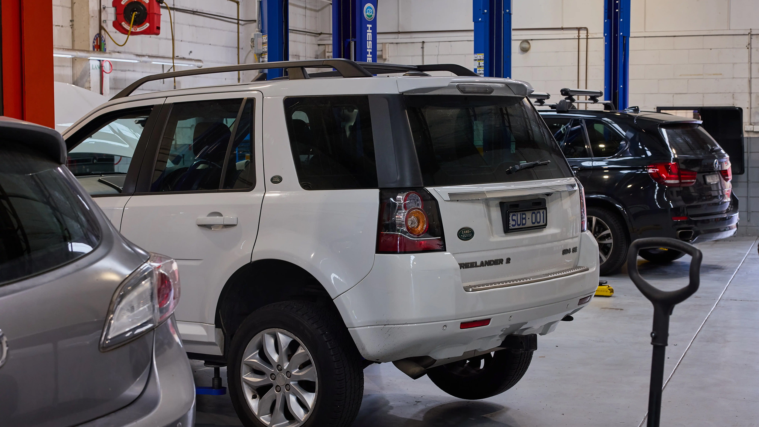 White Land Rover Freelander 2 parked inside the Auto Tech workshop.