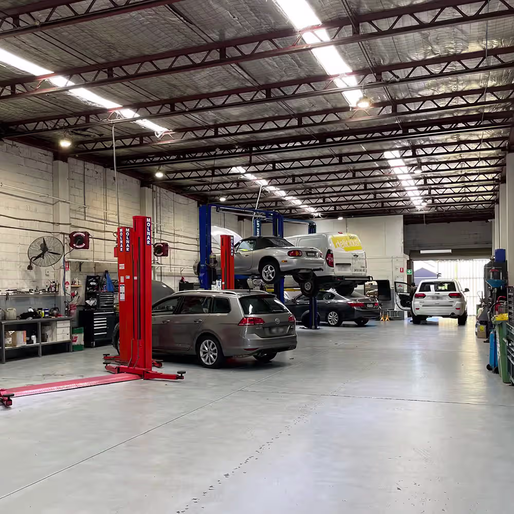 Malvern East workshop interior showing various vehicle brands in the service area.