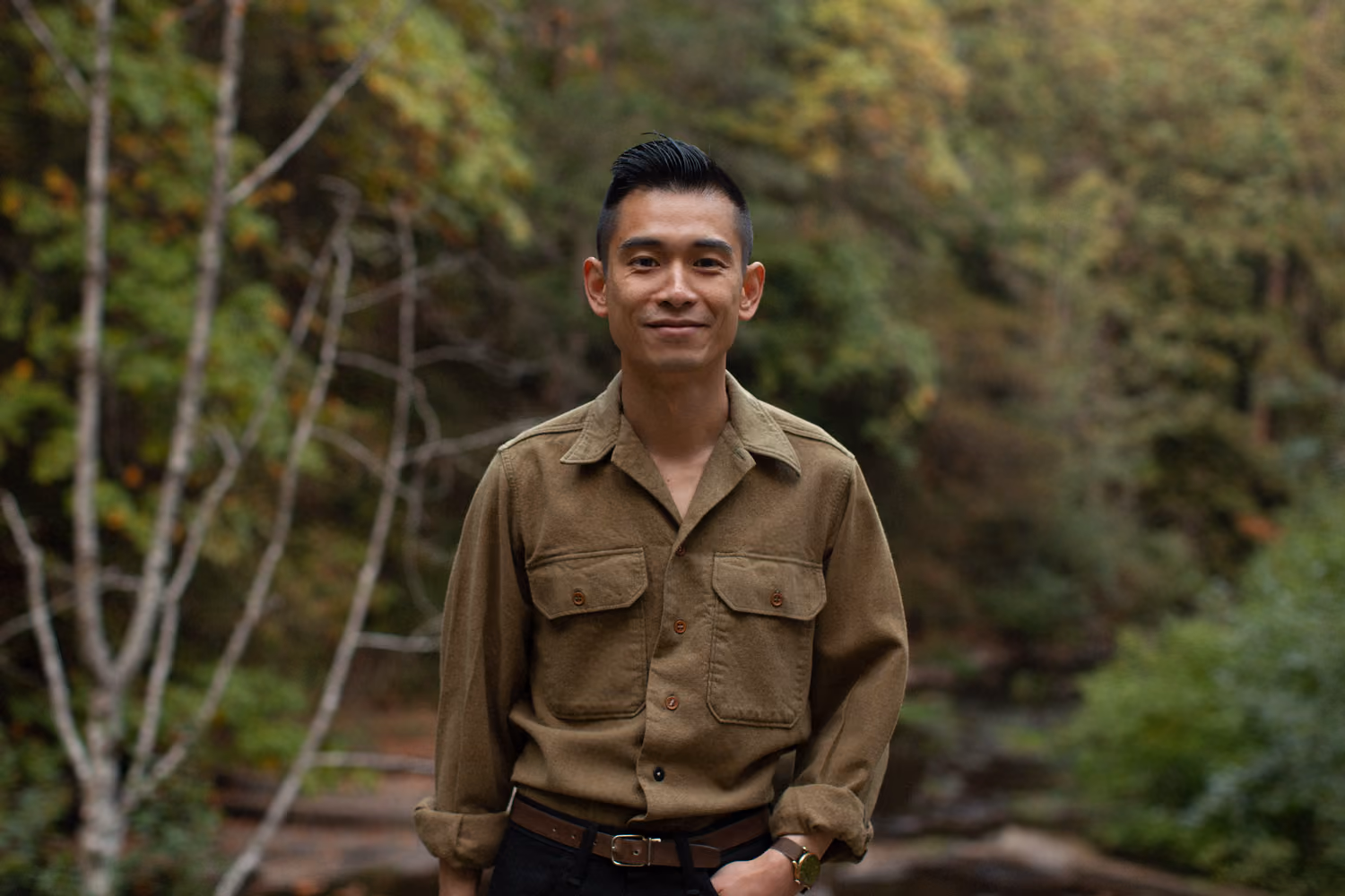A portrait shot of the candidate, Austin Seng, standing in front of a forested area of Bowen Park, Nanaimo.