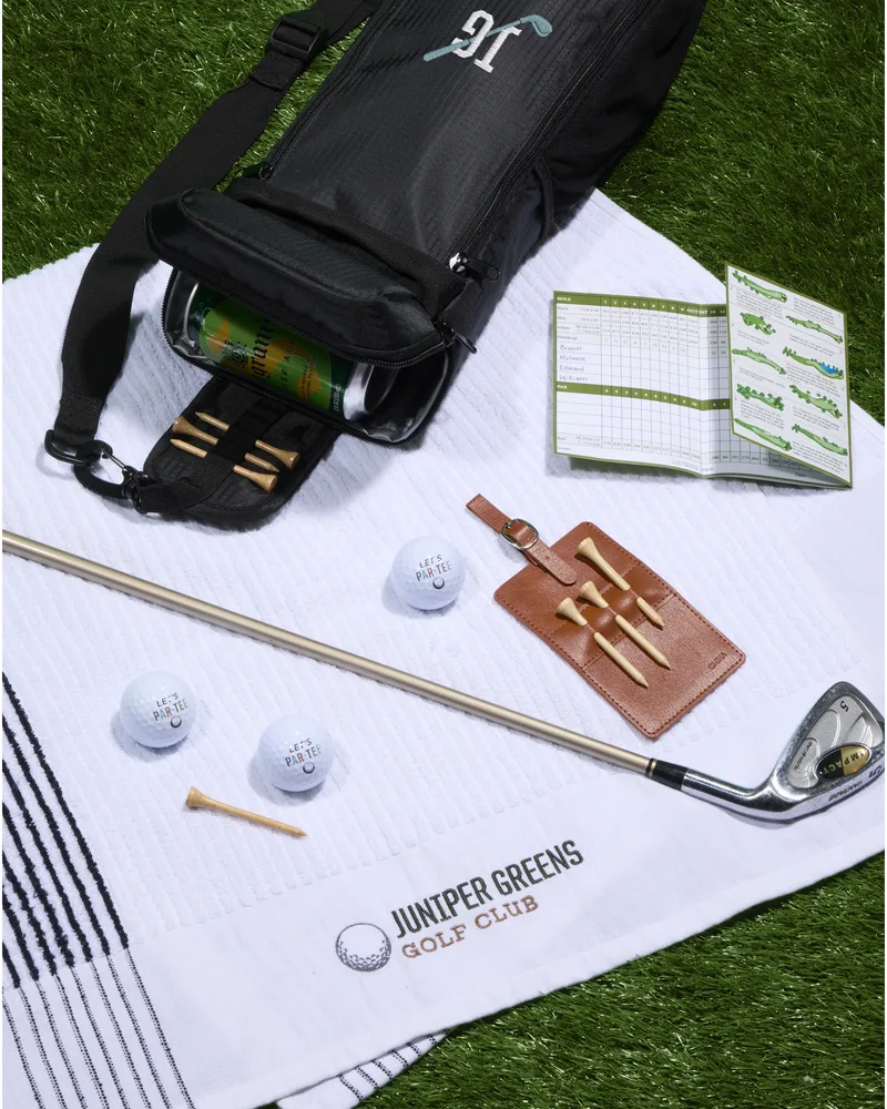 Custom golf gift set with branded towel and tee holder, an example of Maisonette merch
