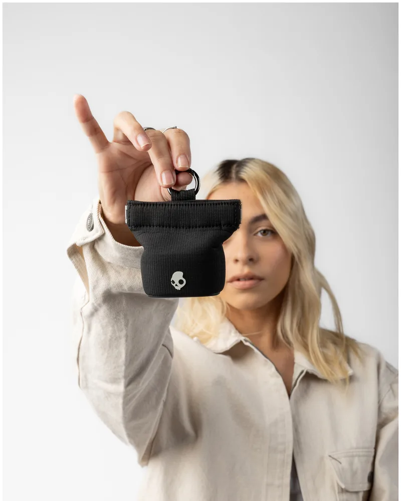 Branded accessory pouch held up by a model, an example of Maisonette merch