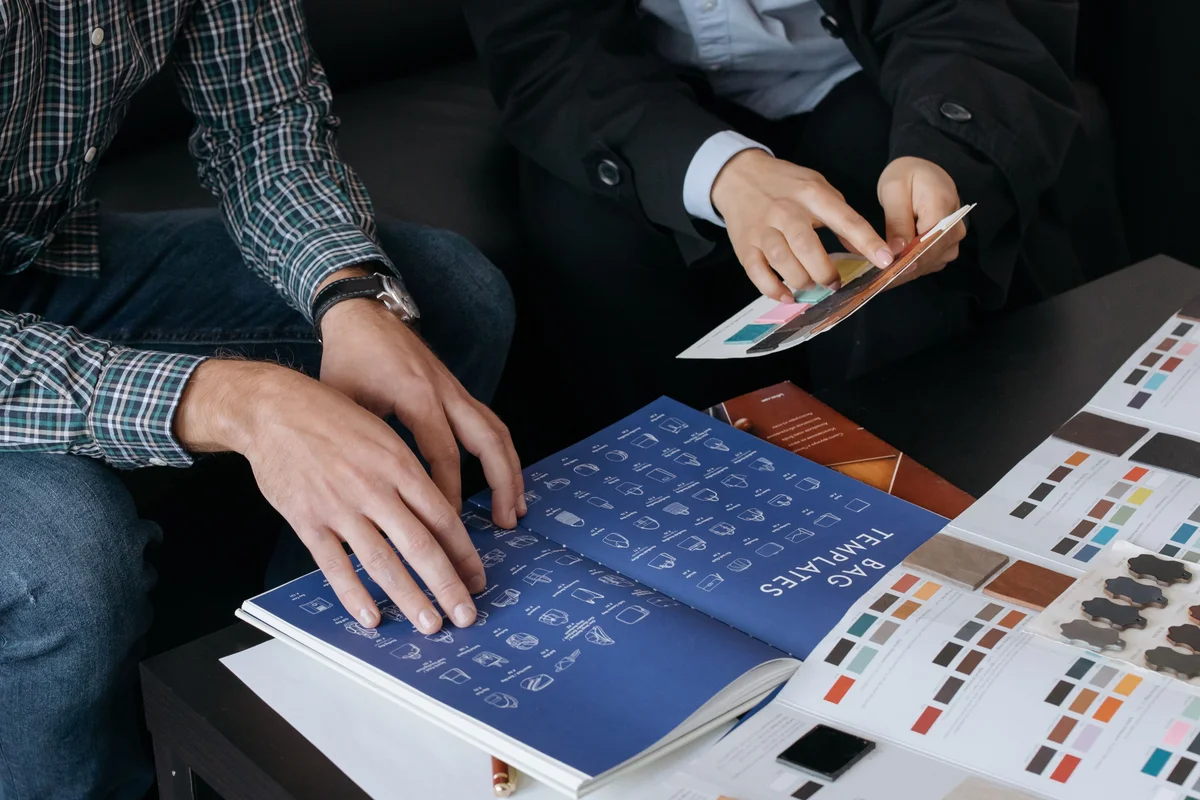 Consultant and client reviewing brand templates and material swatches together