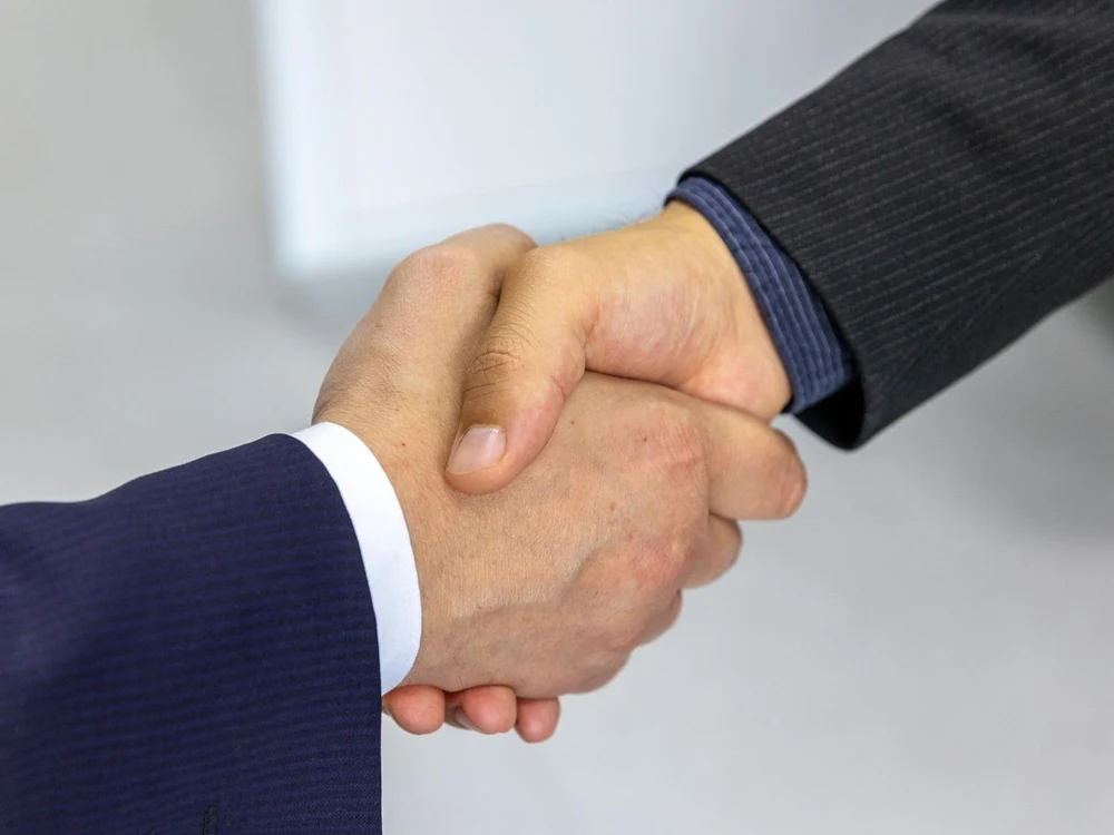 A business handshake closing a partnership deal