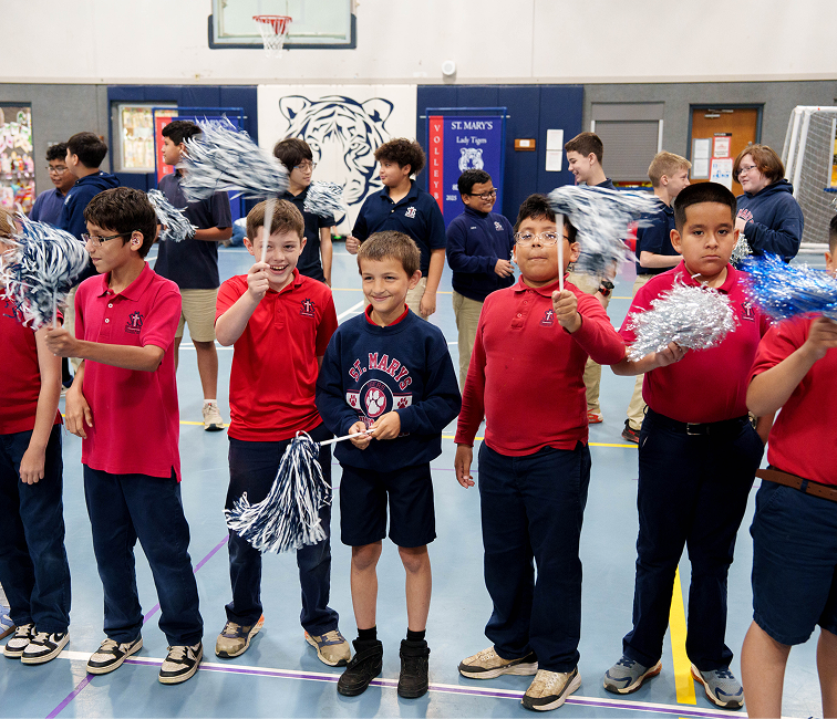 St. Mary's students waving pom-poms during a school pep rally