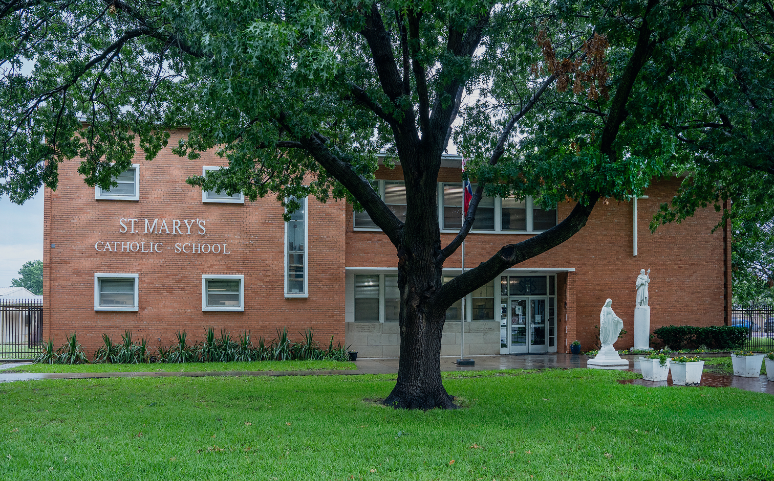 St. Mary's Catholic School brick building entrance with religious statues
