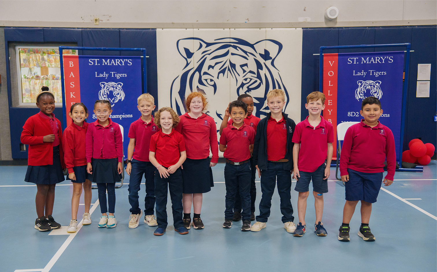 St Mary's students posing together in school gymnasium