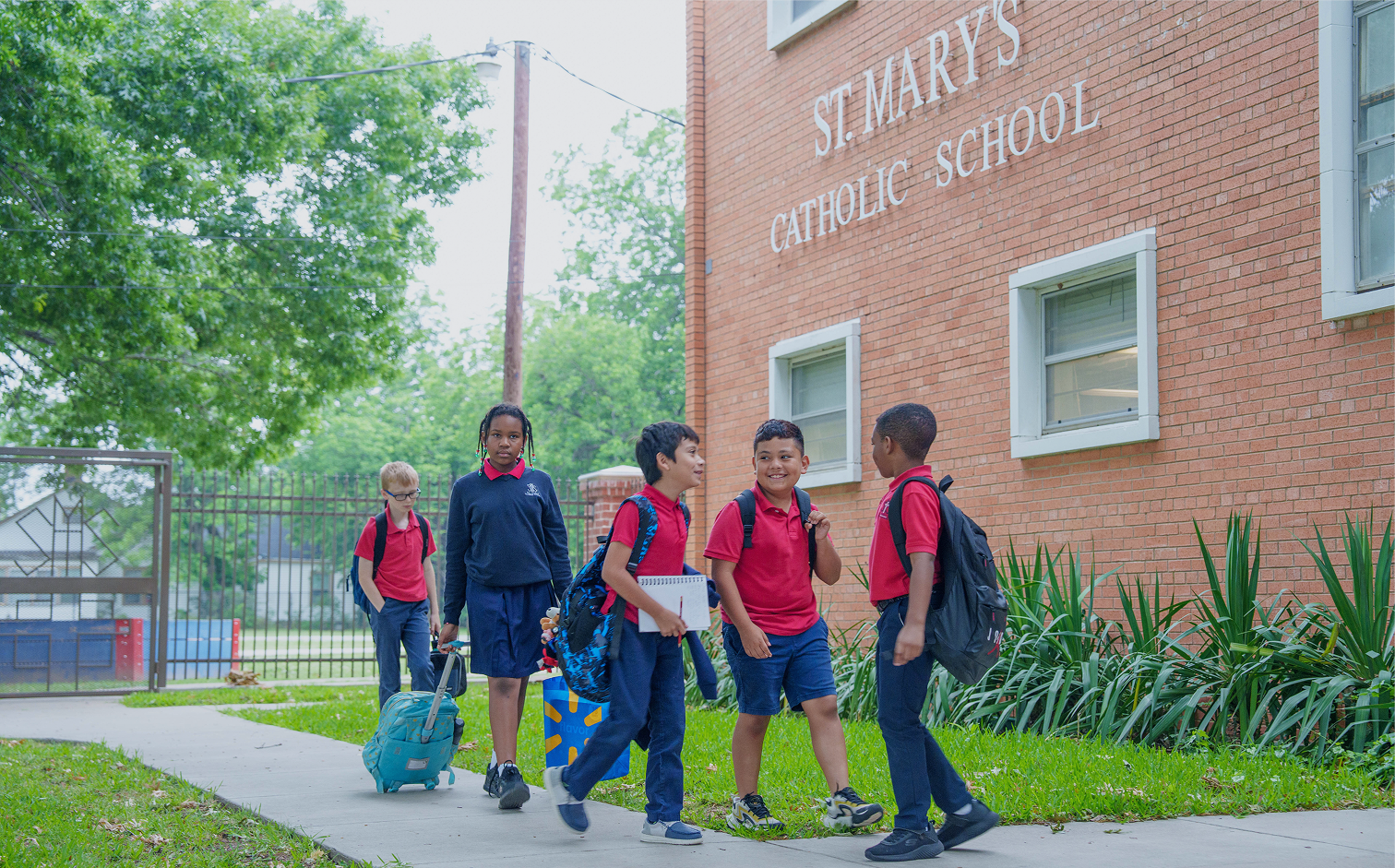 Students in uniforms walking outside St Mary's Catholic School